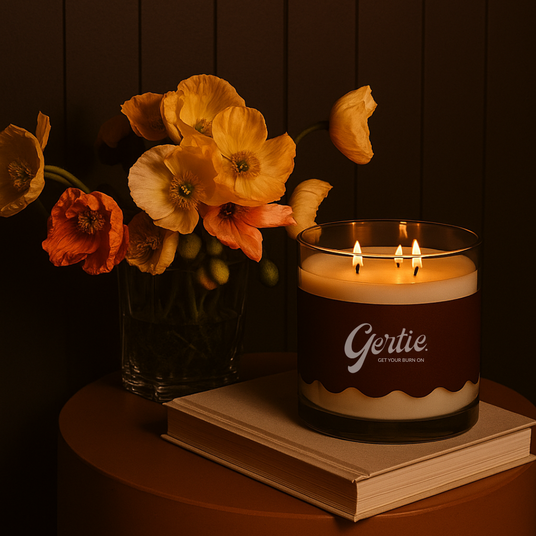 Gertie Candle in a dim room with books and flowers
