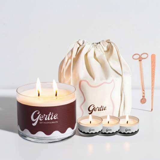 Gertie candle set with a large candle, three small candles, and a drawstring bag on a light background.