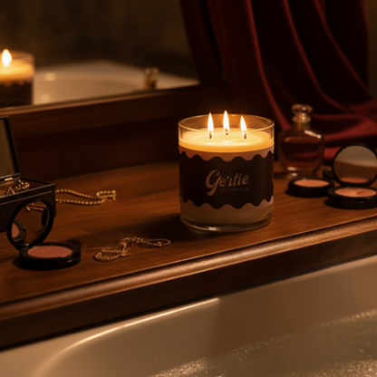 Candle labeled 'Gertie' on a wooden surface with decorative items.