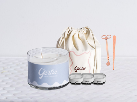 Gertie candle bundle with a drawstring bag with trimmer and dipper on a light background