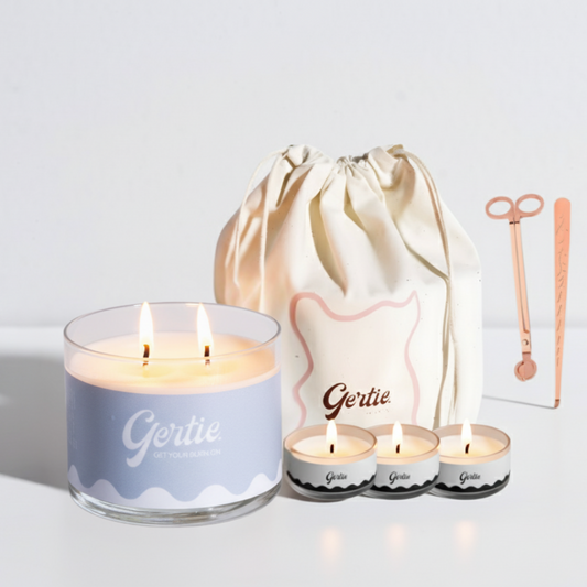 Gertie candle set with a large candle, three small candles, and a drawstring bag on a light background.