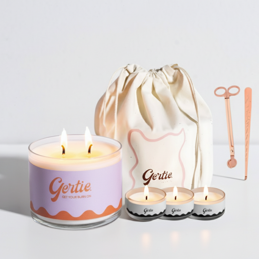 Gertie candle set with a large candle, three small candles, and a drawstring bag on a light background.