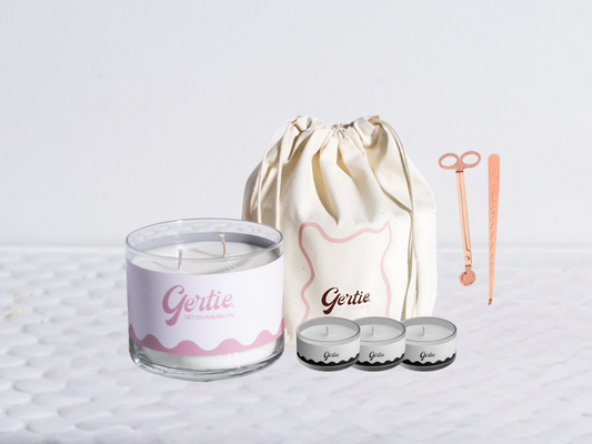 Gertie candle bundle with a drawstring bag with trimmer and dipper on a light background