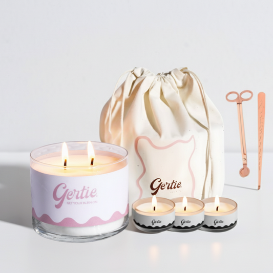 Gertie candle set with a large candle, three small candles, and a drawstring bag on a light background.