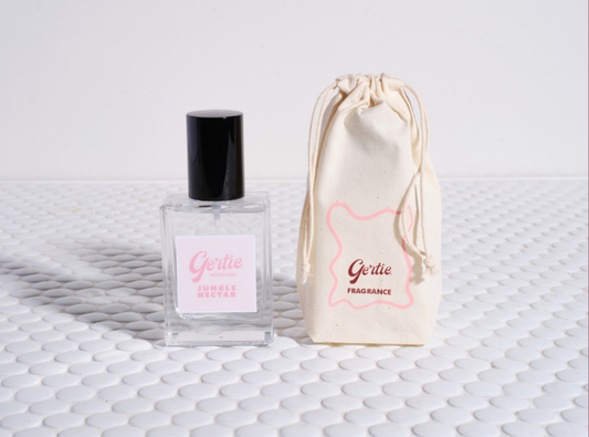 Gertie Jungle Nectar Mist and drawstring bag on a textured surface
