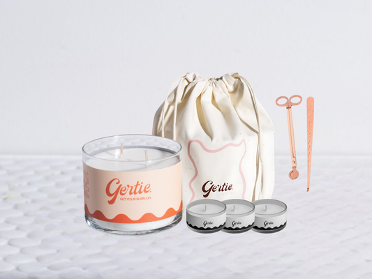 Gertie candle bundle with a drawstring bag with trimmer and dipper on a light background