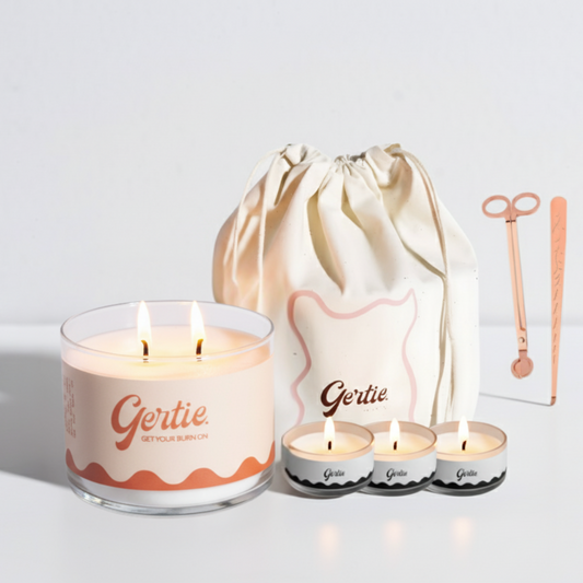 Gertie candle set with a large candle, three small candles, and a drawstring bag on a light background.