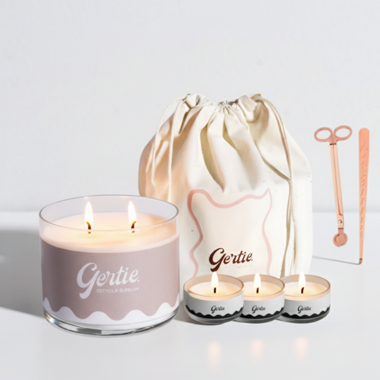 Gertie candle set with a large candle, three small candles, and a drawstring bag on a light background.