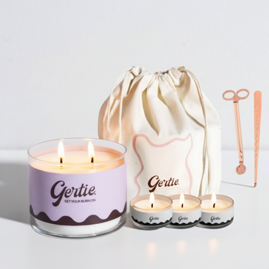 Gertie candle set with a large candle, three small candles, and a drawstring bag on a light background.