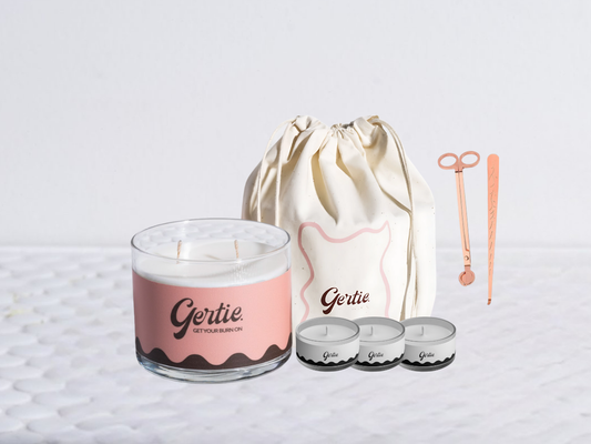 Gertie candle bundle with a drawstring bag with trimmer and dipper on a light background