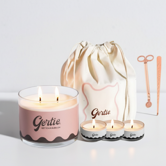 Gertie candle set with a large candle, three small candles, and a drawstring bag on a light background.