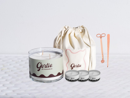 Gertie candle bundle with a drawstring bag with trimmer and dipper on a light background