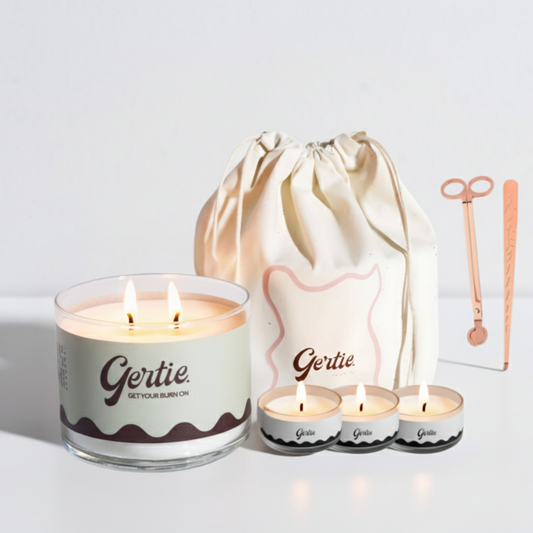 Gertie candle set with a large candle, three small candles, and a drawstring bag on a light background.