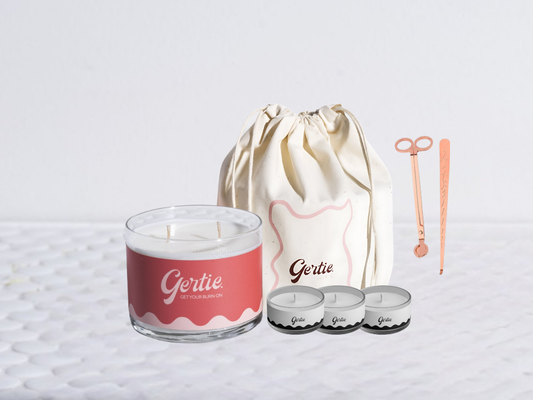 Gertie candle bundle with a drawstring bag with trimmer and dipper on a light background