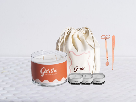 Gertie candle bundle with a drawstring bag with trimmer and dipper on a light background
