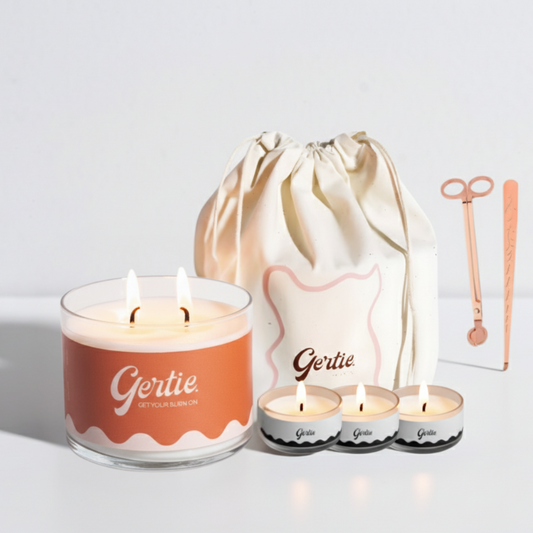 Gertie candle set with a large candle, three small candles, and a drawstring bag on a light background.