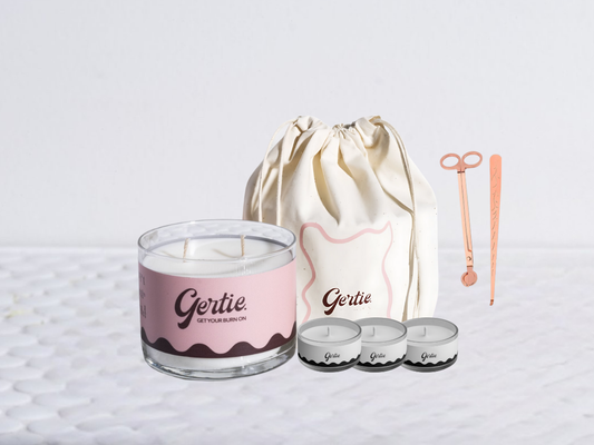 Gertie candle bundle with a drawstring bag with trimmer and dipper on a light background