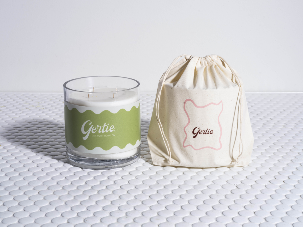 Gertie Sweet Lime  1.2kg Candle and drawstring bag on a textured surface
