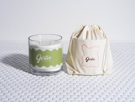 Gertie Sweet Lime  1.2kg Candle and drawstring bag on a textured surface
