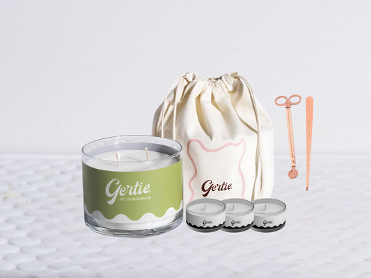 Gertie candle bundle with a drawstring bag with trimmer and dipper on a light background