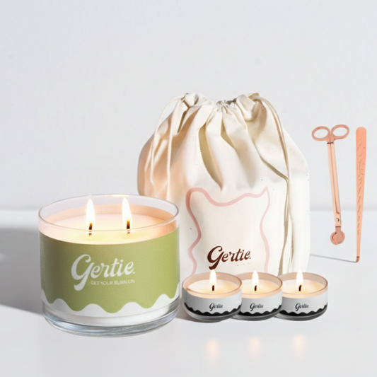 Gertie candle set with a large candle, three small candles, and a drawstring bag on a light background.