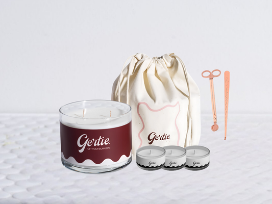 Gertie candle bundle with a drawstring bag with trimmer and dipper on a light background