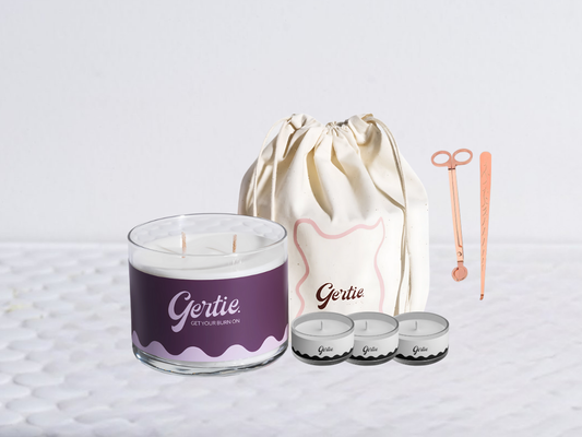 Gertie candle bundle with a drawstring bag with trimmer and dipper on a light background