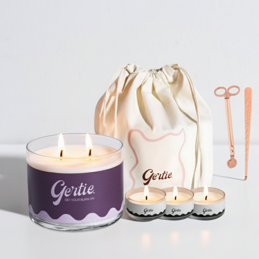 Gertie candle set with a large candle, three small candles, and a drawstring bag on a light background.